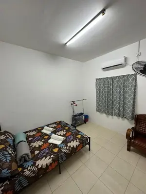 a bedroom with a bed in a room at EmyNuar Homestay in Batu Kurau