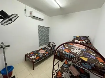 a room with two bunk beds and a fan at EmyNuar Homestay in Batu Kurau