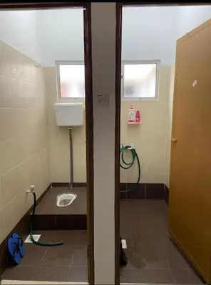 a bathroom with a sink and a toilet in a room at EmyNuar Homestay in Batu Kurau