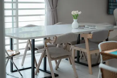 a dining room table with chairs and a vase of flowers at BrandNew Premium House 4Room12Pax@ALMA NEAR JUSCO in Bukit Mertajam