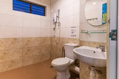 a bathroom with a toilet and a sink at Sea View Penthouse Comfy Home at Batu Ferringhi in Batu Ferringhi