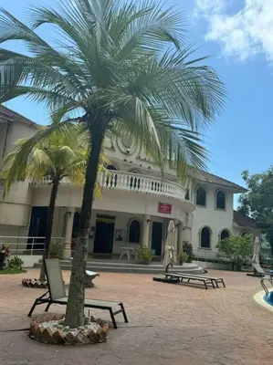 a palm tree in front of a building at Sea View Penthouse Comfy Home at Batu Ferringhi in Batu Ferringhi