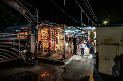 a group of people standing in a market at night at Sea View Penthouse Comfy Home at Batu Ferringhi in Batu Ferringhi