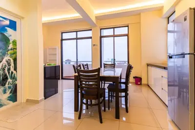 a kitchen with a dining room table and chairs at Sea View Penthouse Comfy Home at Batu Ferringhi in Batu Ferringhi