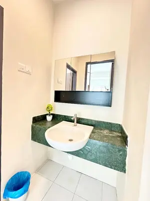 a bathroom with a sink and a mirror at NAUTILUS HOME AT KARPAL SINGH For 14 PAX in George Town