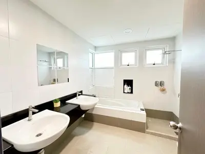 a white bathroom with a sink and a tub at NAUTILUS HOME AT KARPAL SINGH For 14 PAX in George Town