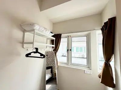 a room with a bunk bed and a window at NAUTILUS HOME AT KARPAL SINGH For 14 PAX in George Town