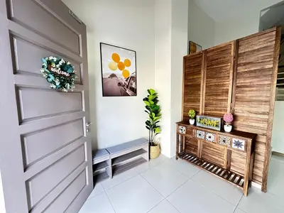 a hallway with a wooden door and a bench at NAUTILUS HOME AT KARPAL SINGH For 14 PAX in George Town