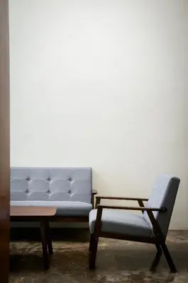 a couch and a chair in a room at Aayu Beach St - George Town Penang in George Town