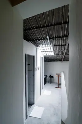 a hallway with white walls and a wooden ceiling at Aayu Beach St - George Town Penang in George Town