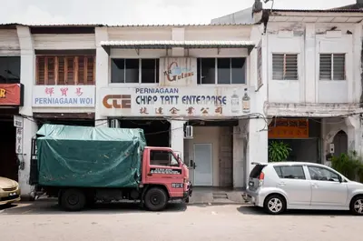 a red truck parked in front of a building at Aayu Beach St - George Town Penang in George Town