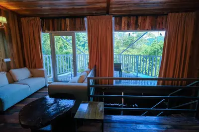 a living room with a couch and a table at Woodcookies Guesthouse in Pangkor