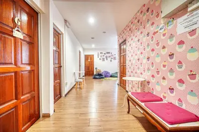 a hallway with a bench and a wall with hearts at Snooze Hotel in Brinchang