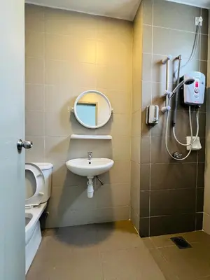 a bathroom with a sink and a toilet and a mirror at Peace Homestay in Cameron Highlands