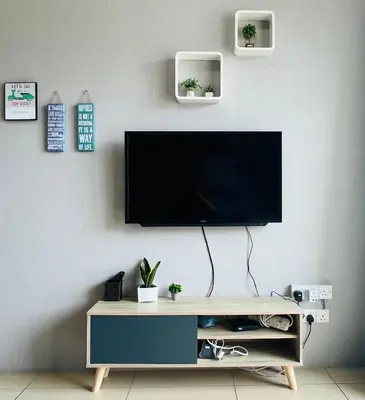 a flat screen tv hanging on a wall at Peace Homestay in Cameron Highlands