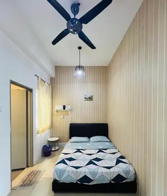 a bedroom with a bed and a ceiling fan at Peace Homestay in Cameron Highlands