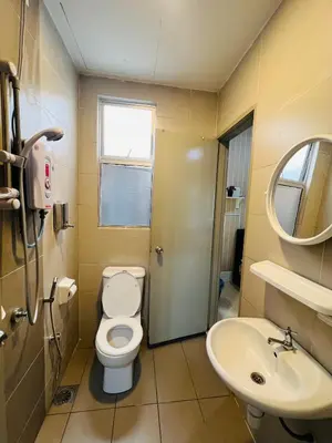 a bathroom with a toilet and a sink at Peace Homestay in Cameron Highlands