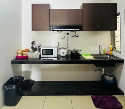 a kitchen with a counter top with a microwave at Peace Homestay in Cameron Highlands