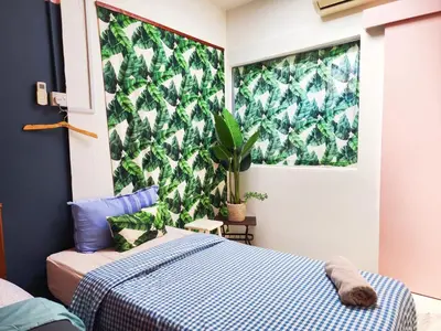 a bedroom with a bed and a green wall at Ipoh Station 18, 4 Bedroom Rainforest LOFT 1 Depan AEON Homestay in Ipoh