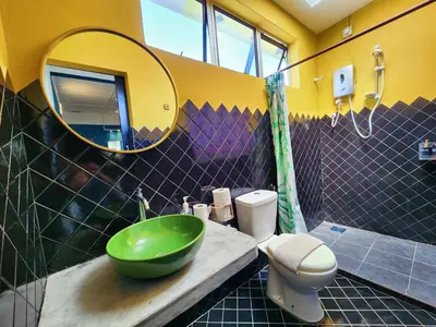a bathroom with a green sink and a mirror at Ipoh Station 18, 4 Bedroom Rainforest LOFT 1 Depan AEON Homestay in Ipoh