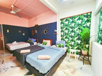 two beds in a room with a large window at Ipoh Station 18, 4 Bedroom Rainforest LOFT 1 Depan AEON Homestay in Ipoh