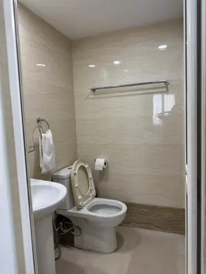 a bathroom with a toilet and a sink at Seaview - Sri Sayang in Batu Ferringhi