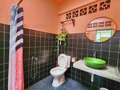 a bathroom with a toilet and a green sink at Ipoh Station 18, Aeon Ipoh Rainforest 2 rooms LOFT 2 Homestay in Ipoh