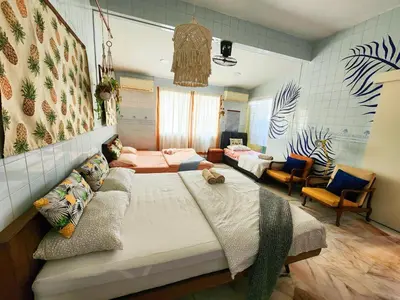 a room with two beds and a couch in it at Ipoh Station 18, Aeon Ipoh Rainforest 2 rooms LOFT 2 Homestay in Ipoh