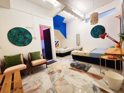 a room with a bed and a table and chairs at Ipoh Station 18, Aeon Ipoh Rainforest 2 rooms LOFT 2 Homestay in Ipoh
