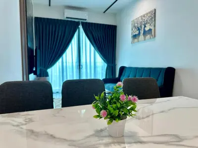 a room with a table with a vase with flowers on it at Suite BigStudio @Meritus Residensi in Perai