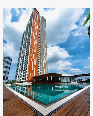 a tall building with a pool in front of it at Suite BigStudio @Meritus Residensi in Perai