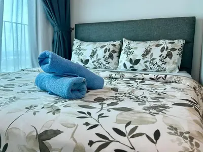 a blue stuffed animal sitting on top of a bed at Suite BigStudio @Meritus Residensi in Perai