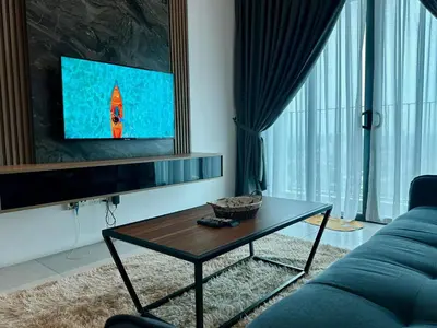 a living room with a blue couch and a table at Suite BigStudio @Meritus Residensi in Perai