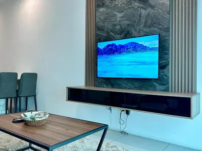 a living room with a flat screen tv on a wall at Suite BigStudio @Meritus Residensi in Perai