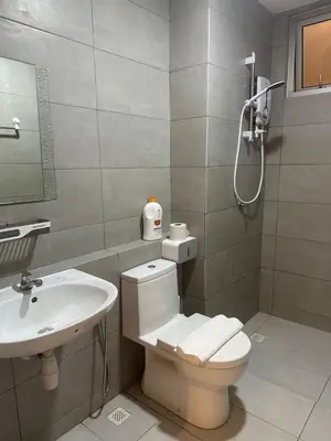 a bathroom with a toilet and a sink at Newly Furnished Metropol Service Apartment with Attractive View in Bukit Mertajam