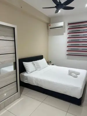 a bedroom with a bed and a ceiling fan at Newly Furnished Metropol Service Apartment with Attractive View in Bukit Mertajam