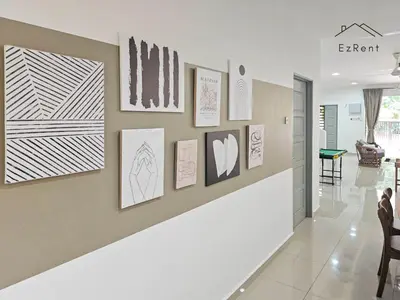 a hallway with art on the wall in a house at Spacious Family 4BR House near Lake Garden Zoo Taiping with Free WiFi and Netflix in Taiping