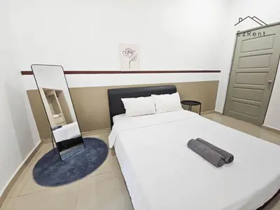 a bedroom with a white bed and a chair at Spacious Family 4BR House near Lake Garden Zoo Taiping with Free WiFi and Netflix in Taiping