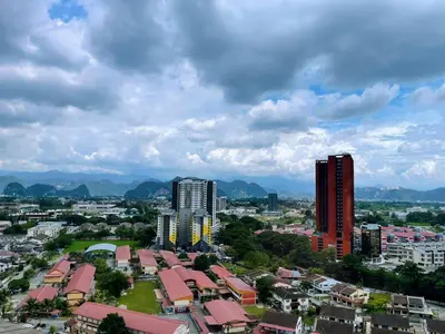 a city with buildings and mountains in the background at Yuru House - The Horizon Ipoh in Ipoh