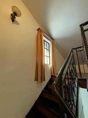 a stairway with a window and a stair case at Cool Point Hotel in Tanah Rata
