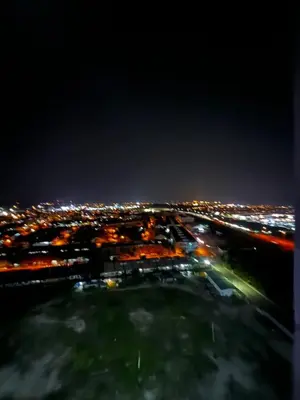 an aerial view of a city at night at Stay in Passionate in Sitiawan