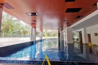 an indoor swimming pool with a red ceiling at Stay in Passionate in Sitiawan