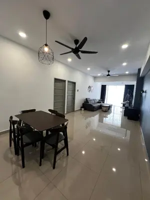 a living room with a table and a ceiling fan at Stay in Passionate in Sitiawan