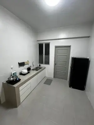 a white kitchen with a sink and a refrigerator at Stay in Passionate in Sitiawan
