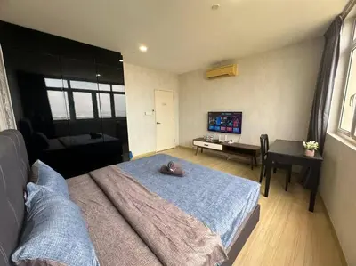 a bedroom with a large bed and a desk at 2BR, 1 Car Park, 4Pax Seaview 118IslandPlaza in Tanjong Tokong