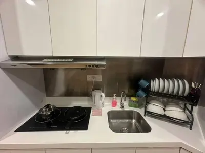 a kitchen counter with a sink and a stove at 2BR, 1 Car Park, 4Pax Seaview 118IslandPlaza in Tanjong Tokong