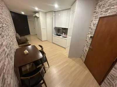 a room with a table and chairs and a kitchen at 2BR, 1 Car Park, 4Pax Seaview 118IslandPlaza in Tanjong Tokong