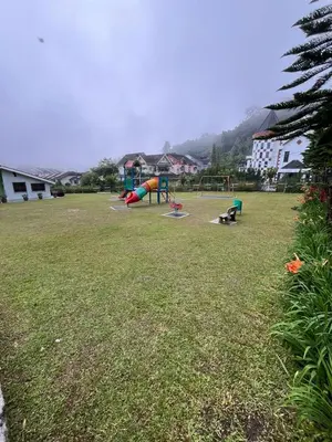 a park with playground equipment in a grass field at Azzalea's Apartment Ground Floor Cameron Highlands in Tanah Rata