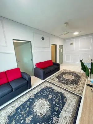 a living room with two couches and a rug at Azzalea's Apartment Ground Floor Cameron Highlands in Tanah Rata