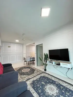 a living room with a couch and a tv at Azzalea's Apartment Ground Floor Cameron Highlands in Tanah Rata